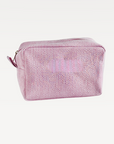 Pink textured toiletry bag with a zipper on a white background