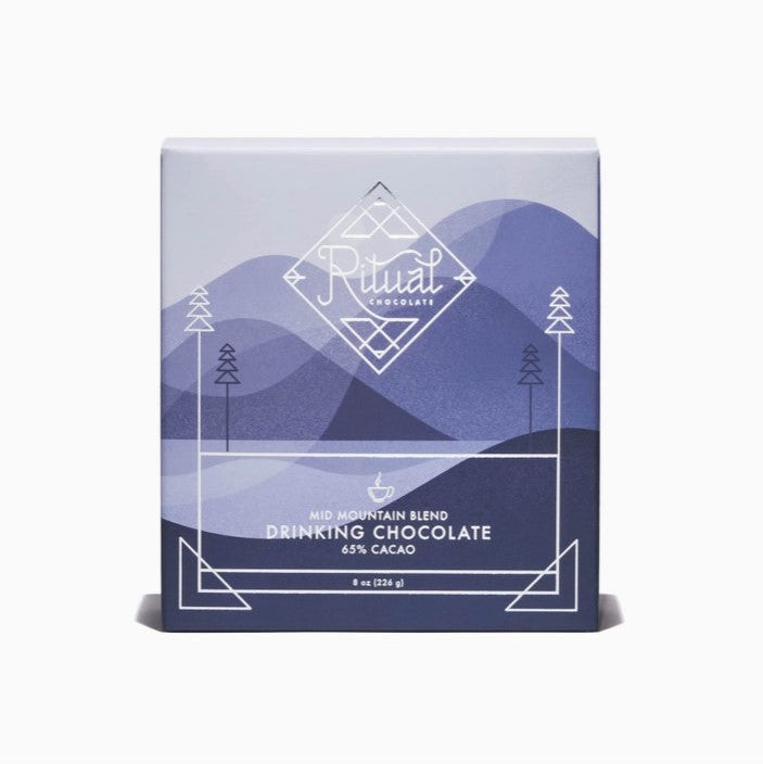 Ritual mid mountain chocolate is featured in its square shaped package with blue shades mountains illustration. as background and white lettering. 