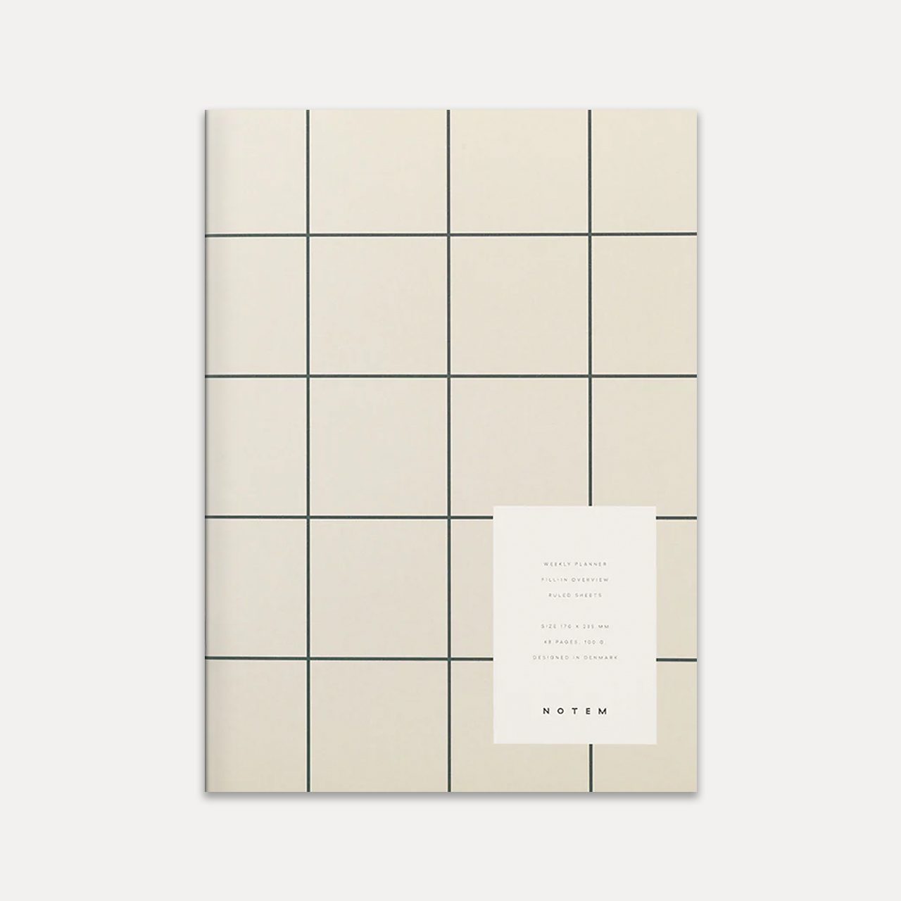 Milo weekly planner notem light grey cover featured, a rectangular planner, its surface marked by a dark gray grid over a pale beige background. Positioned on the lower right, a white rectangular label provides details of the planner in black lettering.
