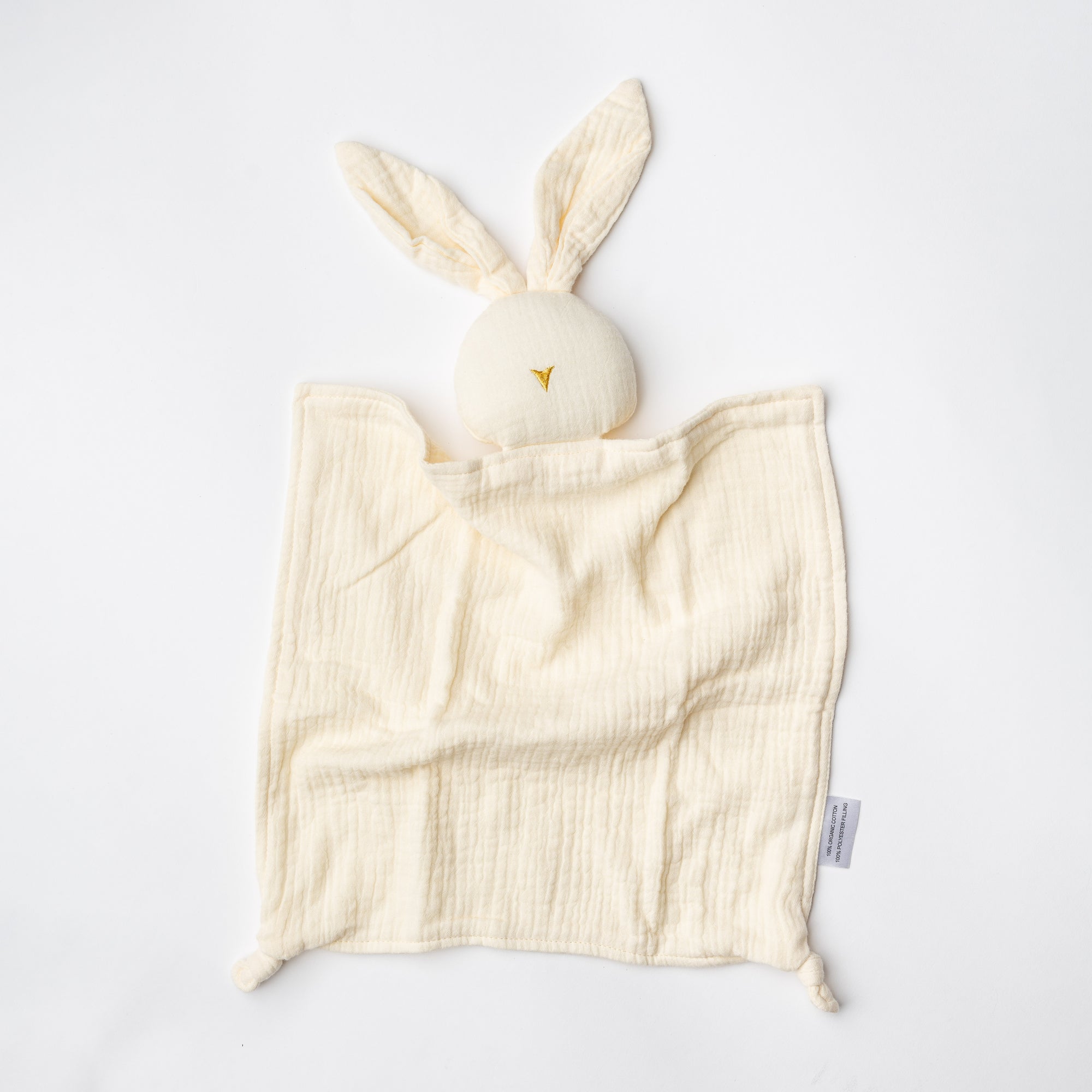 Organic bunny blanket in beige color on a white background. 