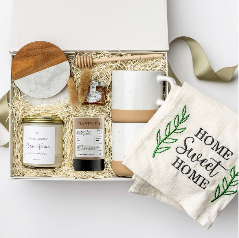 Gift set with a mug, tea, candle, and towel on a white background