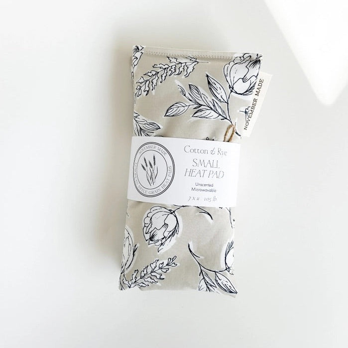November Made heating pad with floral patterns on a white background. 