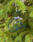 Personalized cat ornament, featuring an image of a cat crafted from blue wire that forms the outline of a cat's body and head, complete with a white bow and a silver bell. In the center is personalized with the name Milo in white aluminum wire, with a christmas tree in the background.