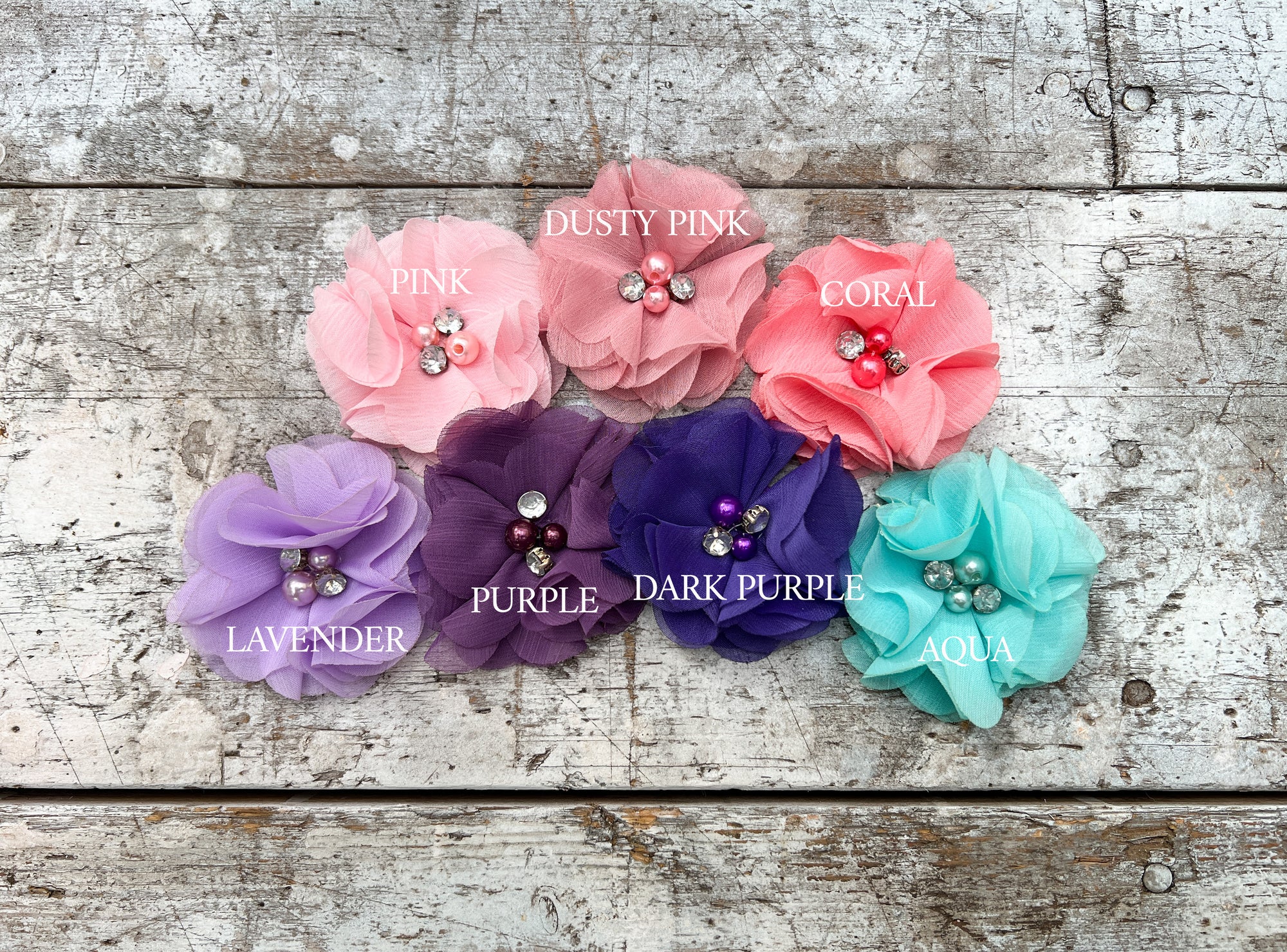 Personalized flower girl chiffon flower color options in a wooden background. 