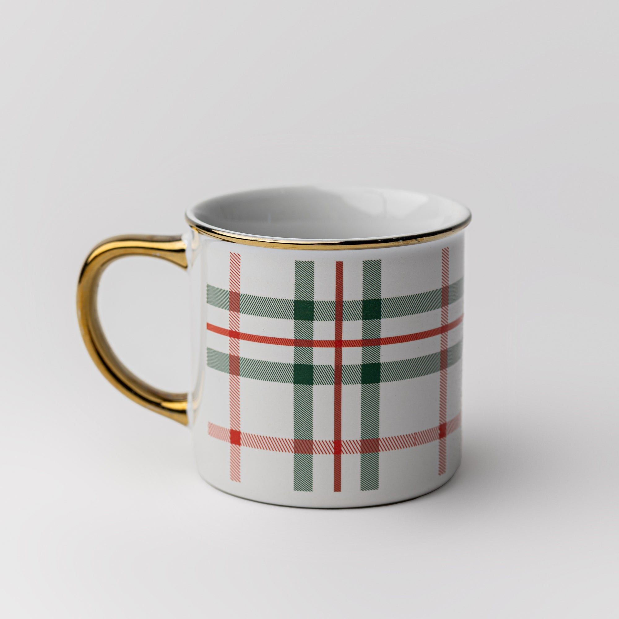 Our signature plaid mug gold rim and handle featured being held with chocolate and marshmallows inside on a white background.