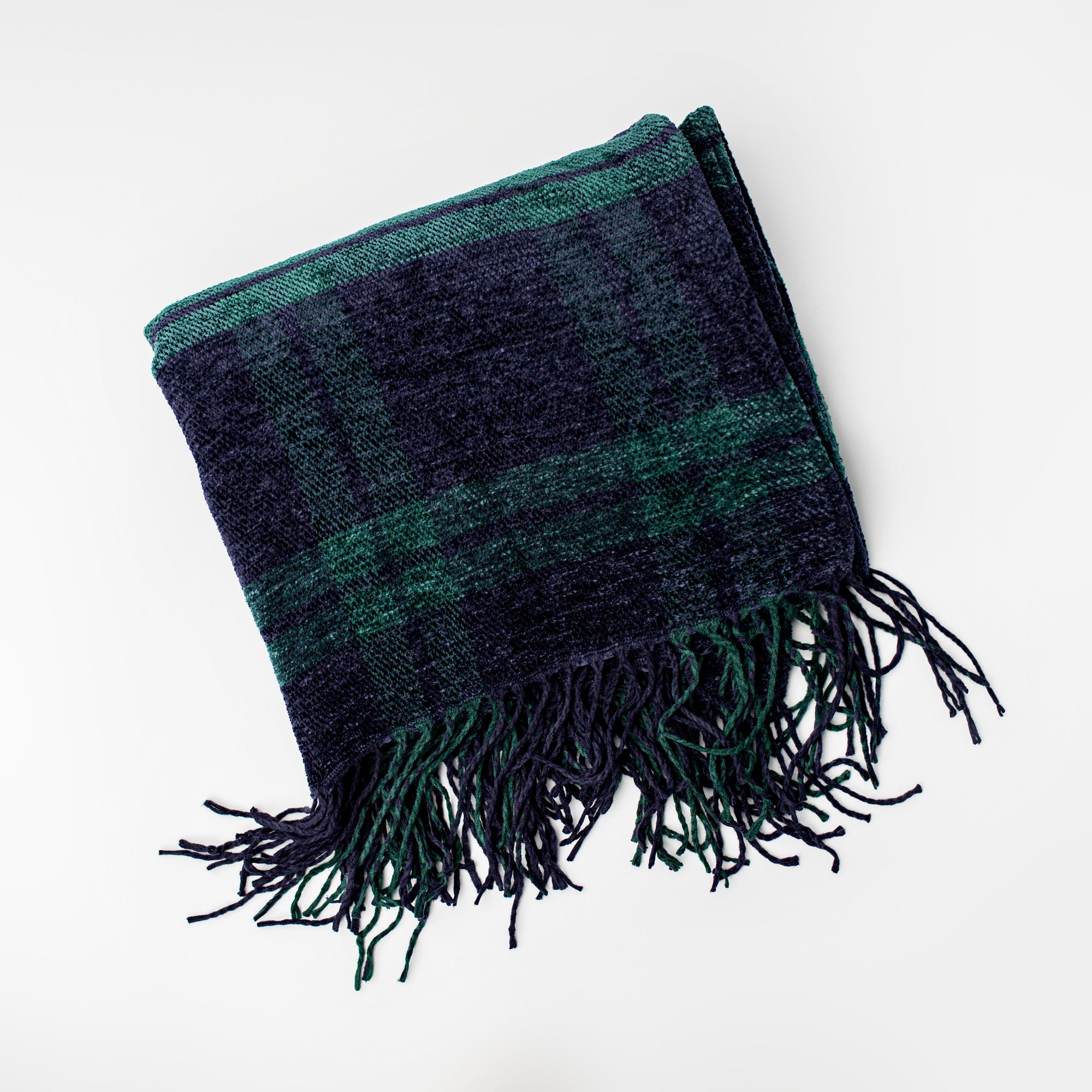 Plush plaid throw blanket is featured in its green and blue lines on a white background. 