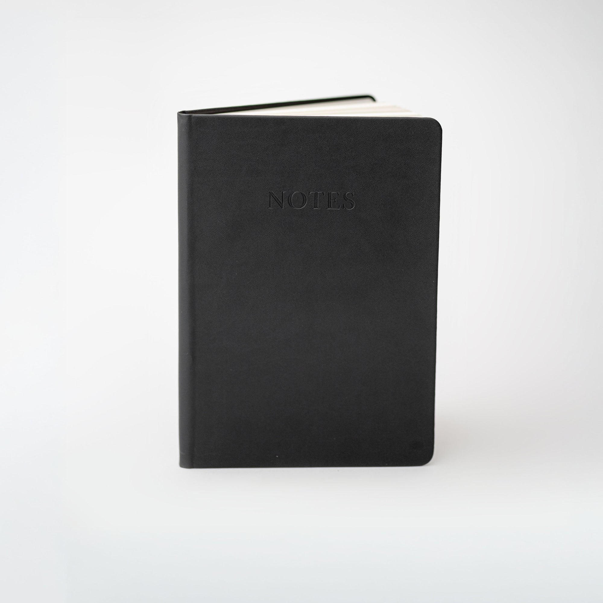 Black notebook with 'NOTES' embossed on the cover against a white background