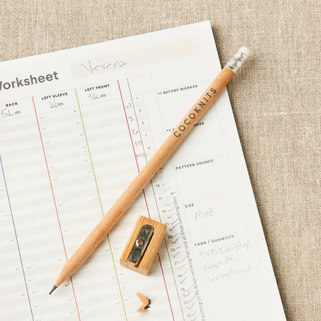 Pencil and sharpener on a worksheet with 'Cocoonits' branding.