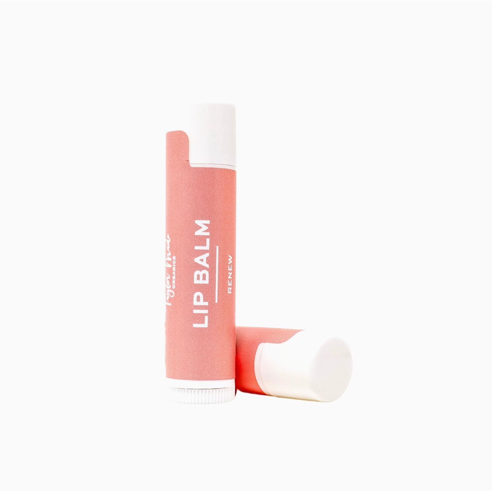 Lip balm with a white cap and coral label on a white background