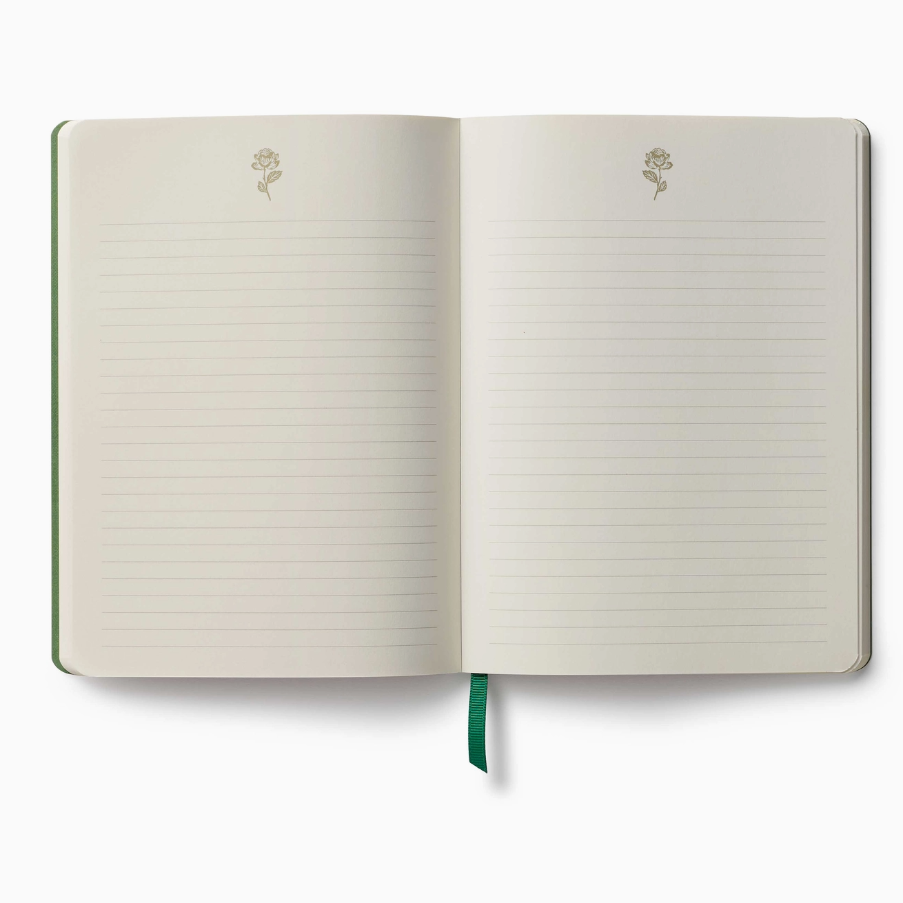 Open softcover journal showing two pages of lined paper with a pale pink ribbon bookmark running down the center and with a rose detail in gold on thew top of the page. 
