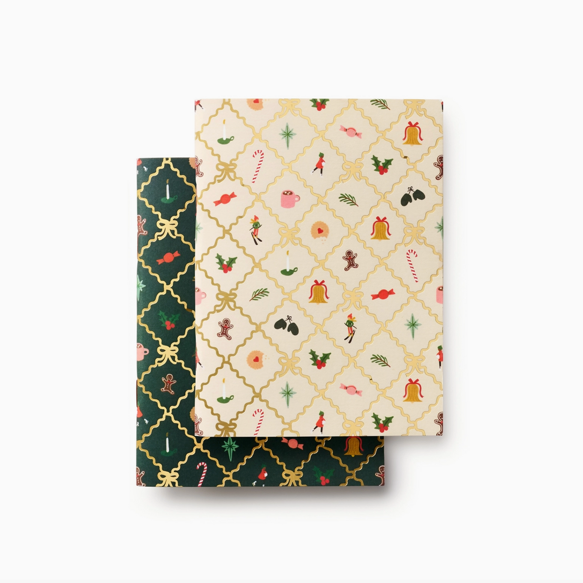 Two square sheets of patterned paper or cardstock stacked slightly offset on a light gray background. The top sheet has a cream background with a gold trellis pattern and small Christmas motifs including bells, candy canes, holly, and ornaments.