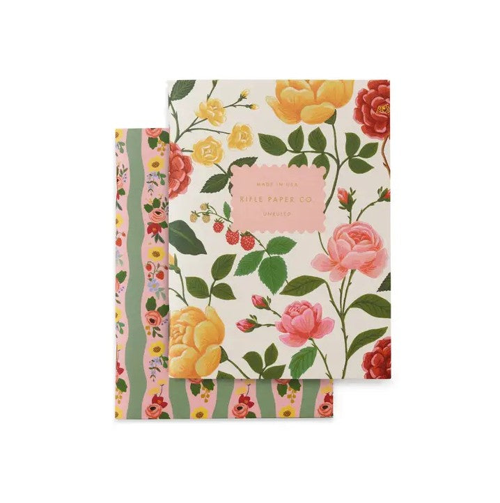 Rose Pocket Notebook, image of roses pocket notebook from rifle paper, front cover of the two notebooks. Shows cream notebook with roses with pink label. Second notebook, has a pink background with green stripes and roses. 