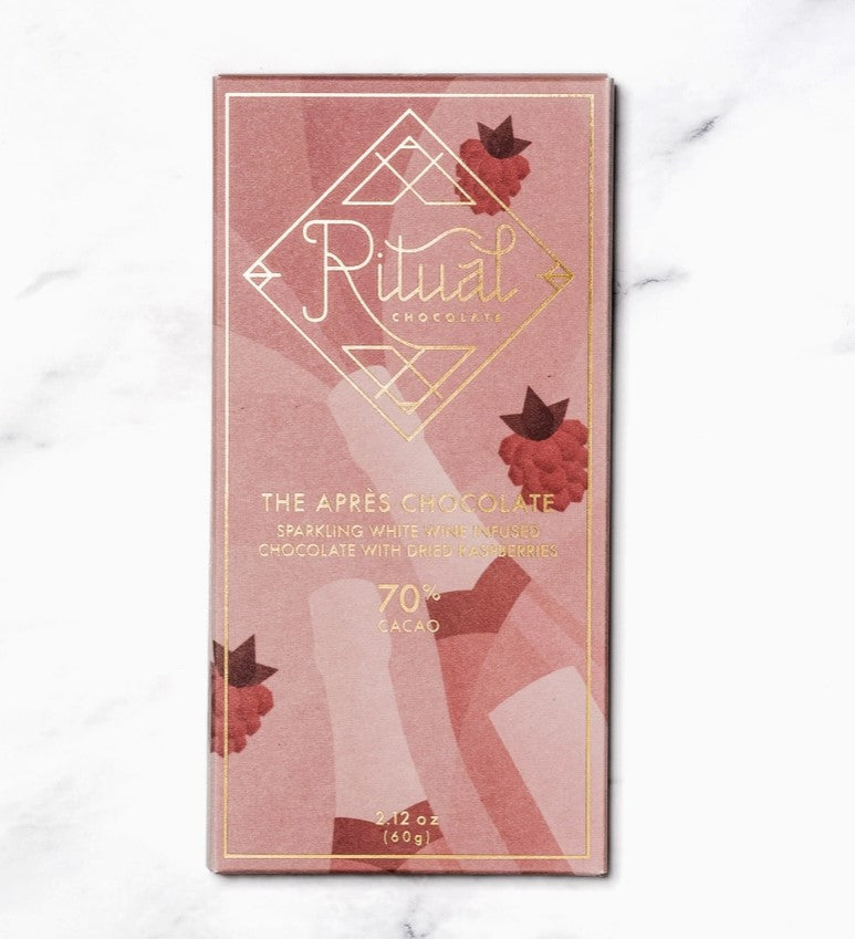 Ritual the Apres Chocolate, wrapped in a pink wrap with raspberries and sparkling wine background image. The label in gold lettering.