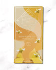 Honeycomb Ritual chocolate bar,A gold and beige packaging for a honeycomb toffee dark chocolate bar from Ritual. The image displays a predominantly gold and beige color scheme with a graphic design that features stylized honeycomb shapes.