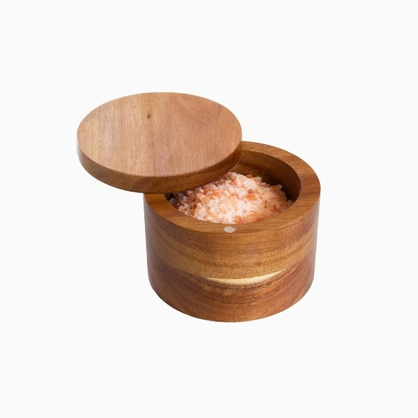 Acacia wood salt cellar by Rock & Branch on a white background, featuring a smooth natural grain finish with a small hinged or open-lid design for storing cooking salt or spices in a rustic kitchen setting.