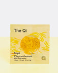 Royal Chrysanthemum whole flower infusion, image shows the package that the flower comes in, is a light yellow sachet with background image of pieces of the flower across it, revealing in a round transparent opening the sachet has the flower itself. 