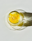 Royal Chrysanthemum, whole flower infusion, the image shows the yellow flower as it's served in a transparent mug. 