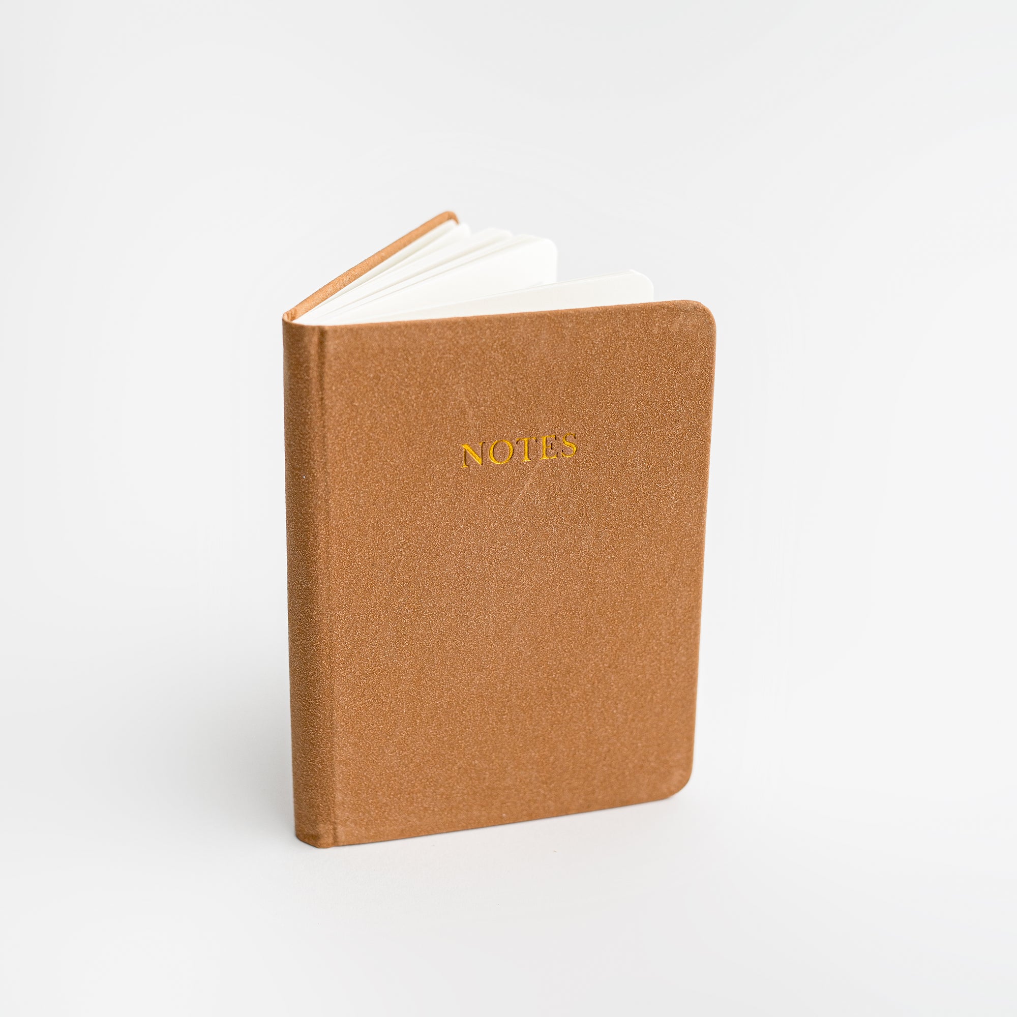 Rust pocket softcover notebook featured on a white background.  With Notes printed in front of it. 