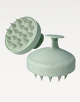 Side and bottom image of scalp massager is featured on a white background. 