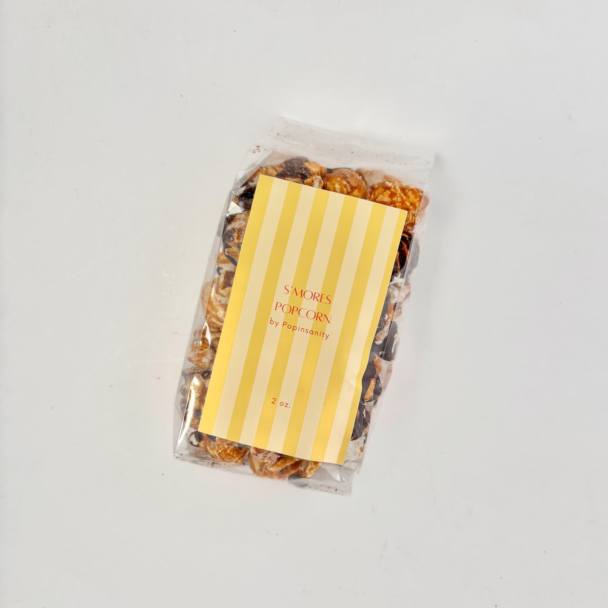 Packaged popcorn with a yellow label on a white background