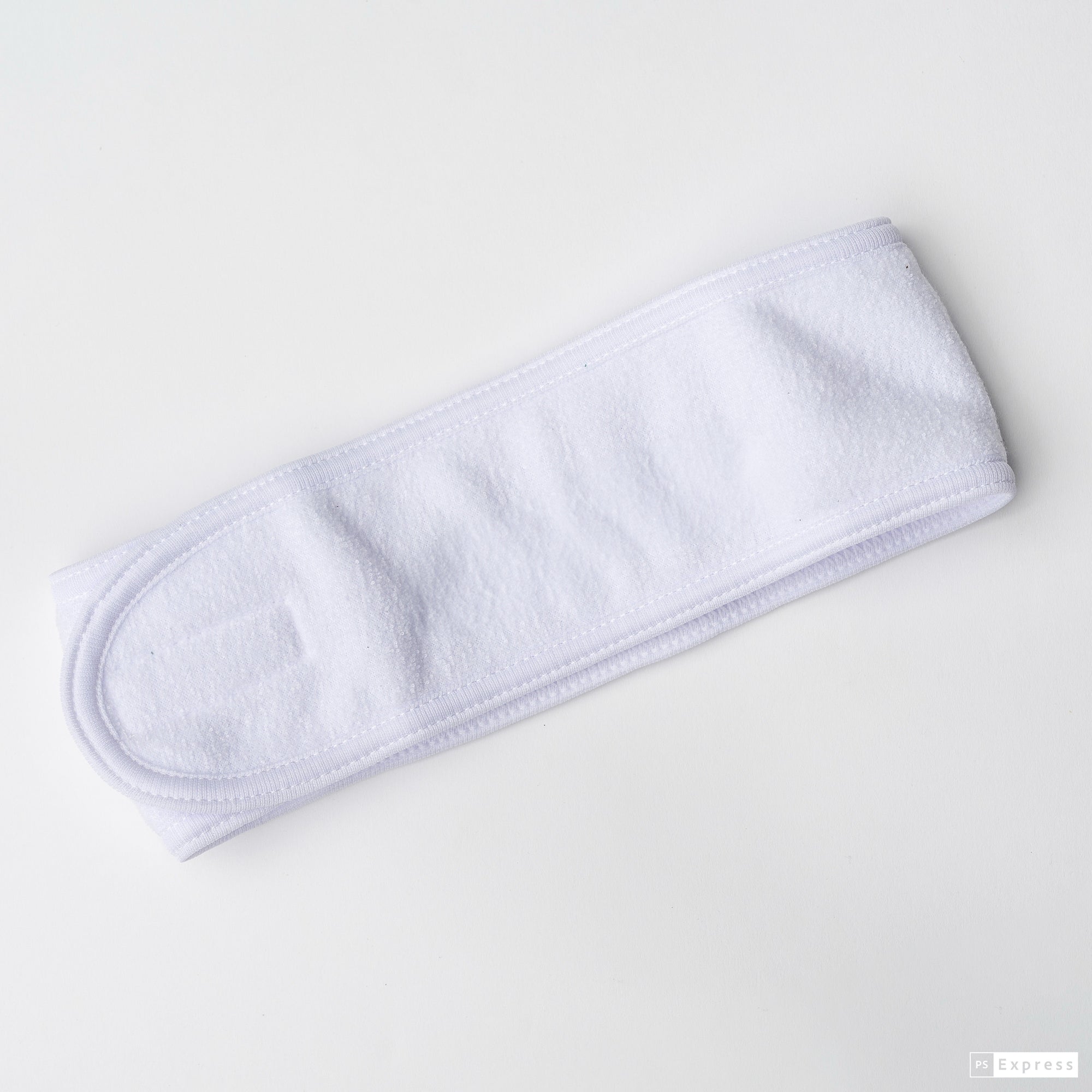Image of white spa headband in a white background.