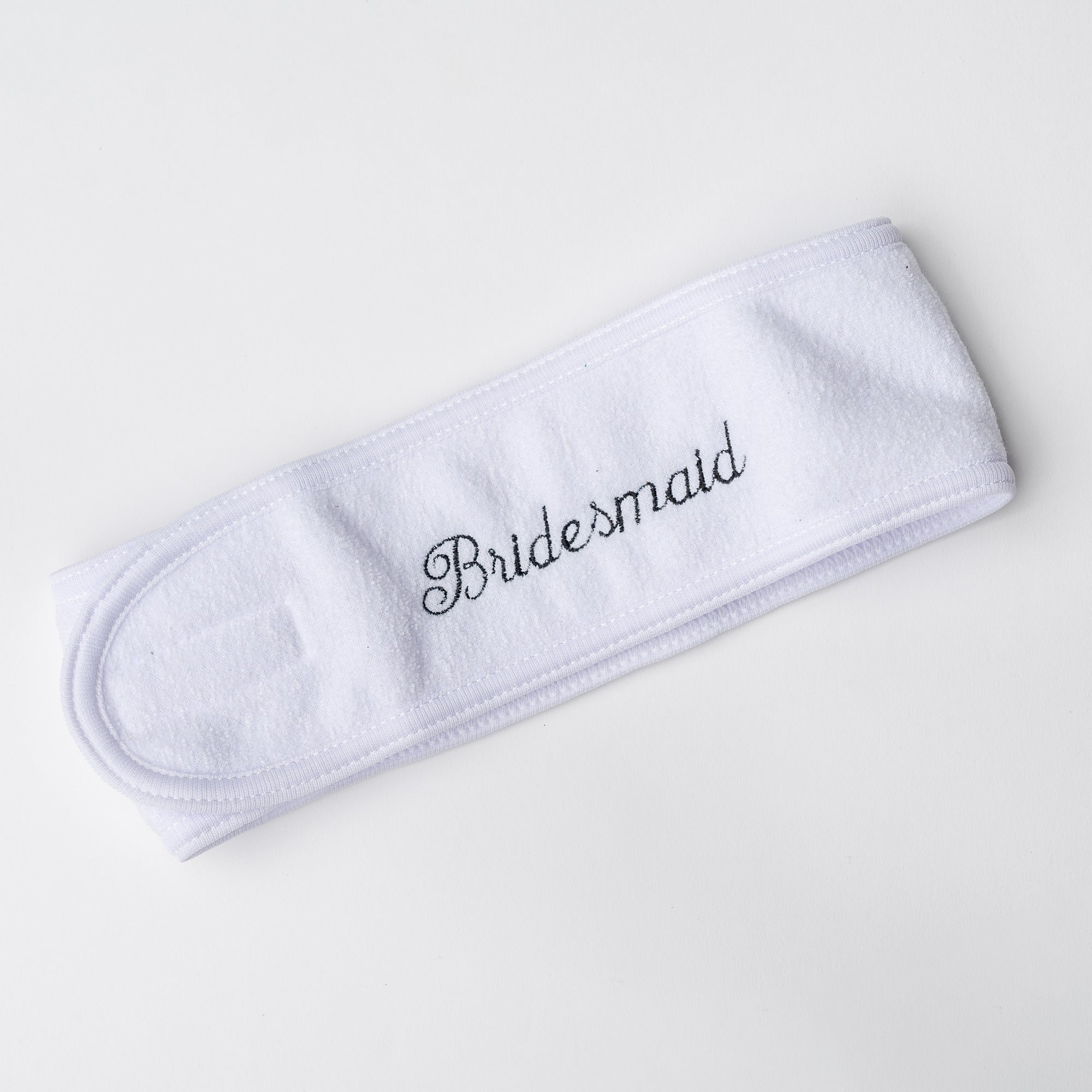 Plush white spa headband worn to keep hair away from face during skincare routine personalized in black thread bridesmaid. 