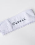 Plush white spa headband worn to keep hair away from face during skincare routine personalized in black thread bridesmaid. 