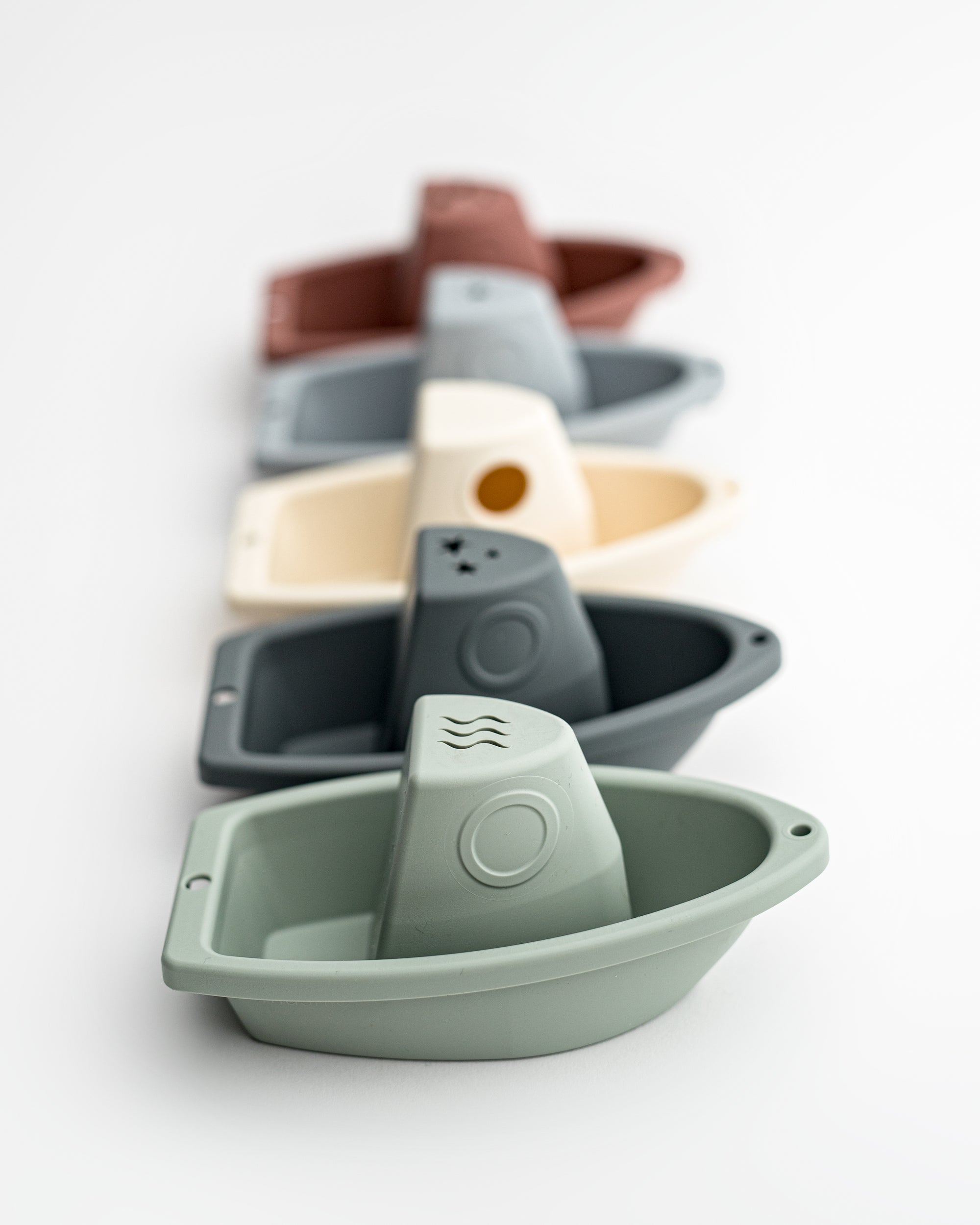 set of five stacking bath boats in various colors on a white background. 