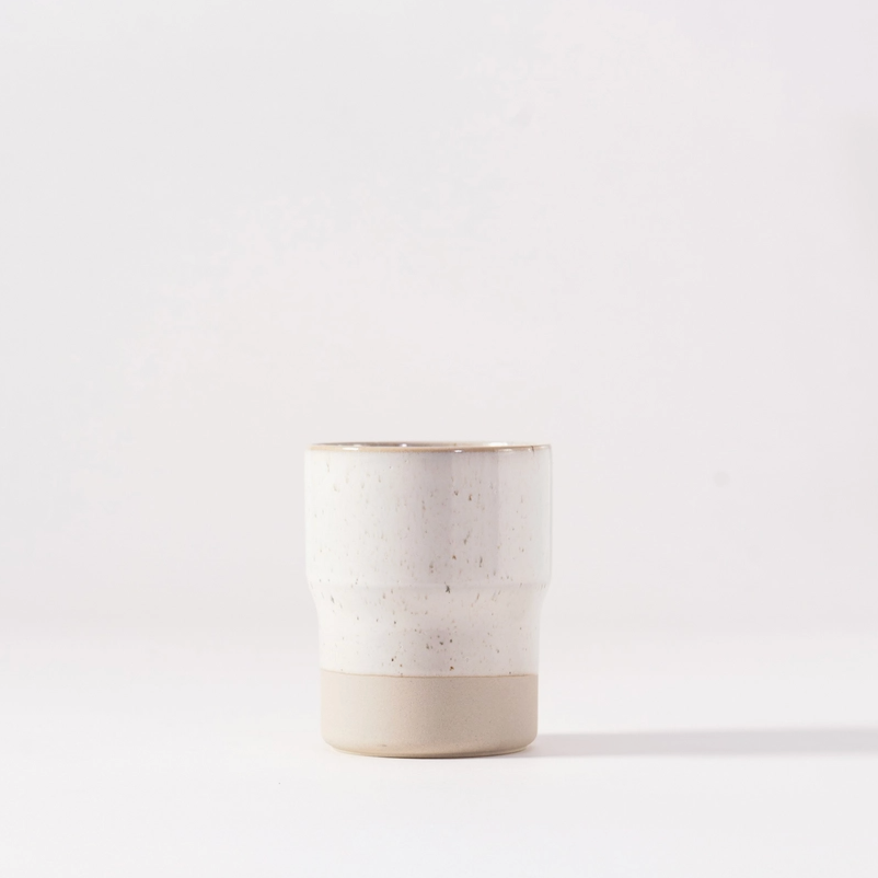 Ceramic cup with two-tone design on a white background