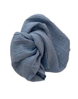 Blue muslin swaddle on a white background. 