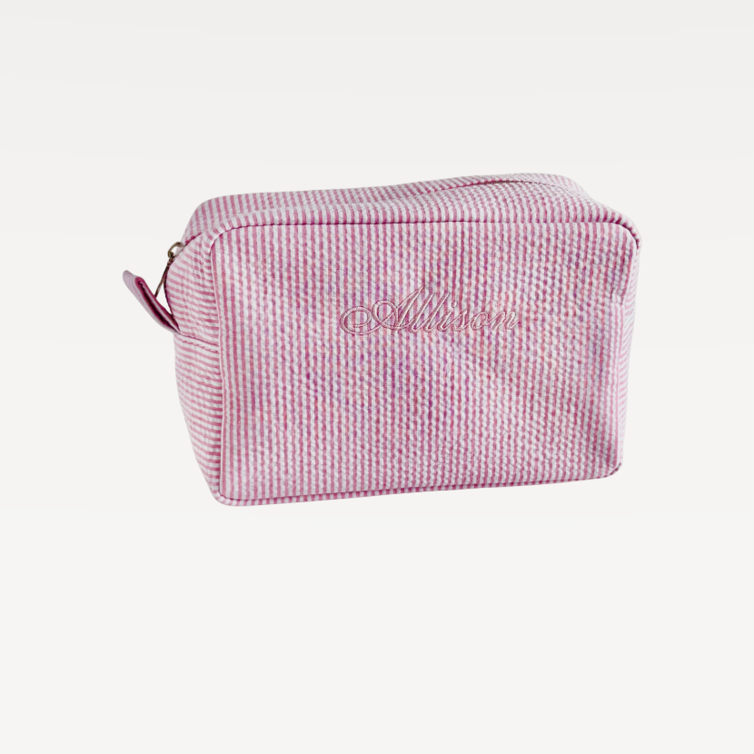 Pink textured cosmetic bag with 'Allison' branding on a light gray background