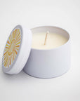 Sunshine natural soy candle in its white ceramic jar and white round label on top of the lid with a sun and in white lettering in the middle of it a little sunshine to brighten your day on a white background. 