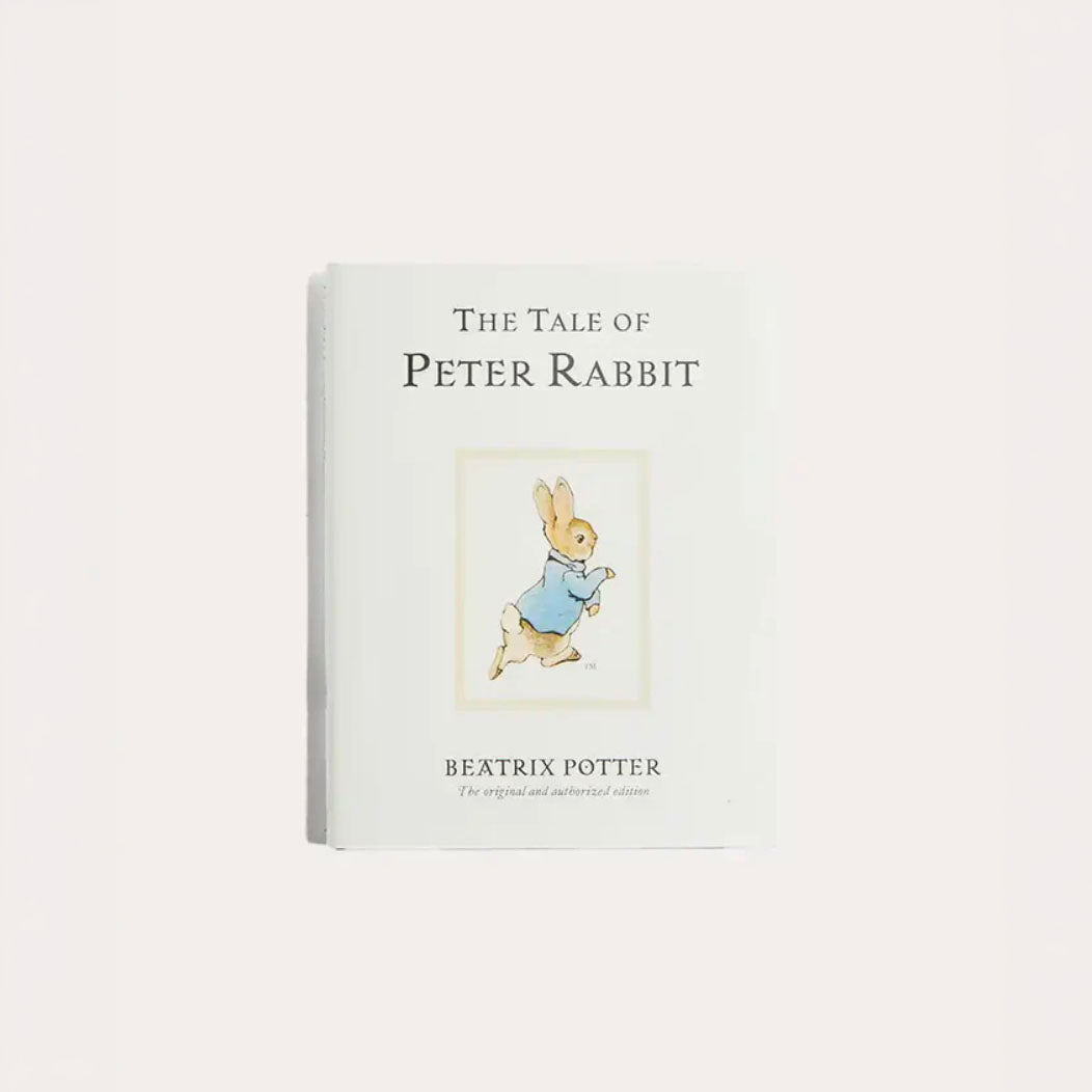 The Tale of Peter Rabbit hardcover children’s book shown closed with the illustrated cover featuring Peter Rabbit, centered on a clean white background with soft lighting.