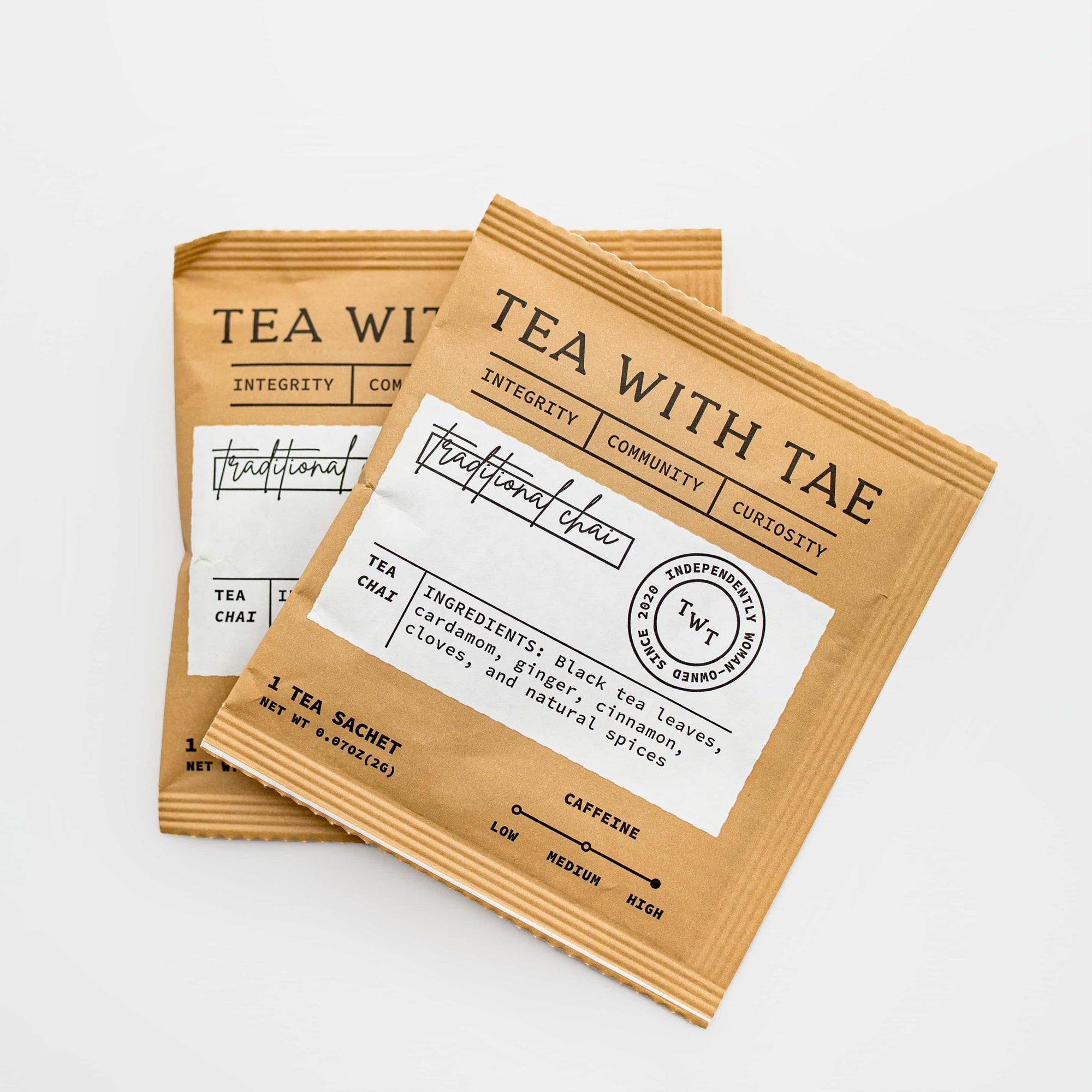 Traditional Chai tea sachets, featuring two squared kraft-paper container of “Traditional Chai” tea sachets. The container is light brown with a clean, minimal white label printed.