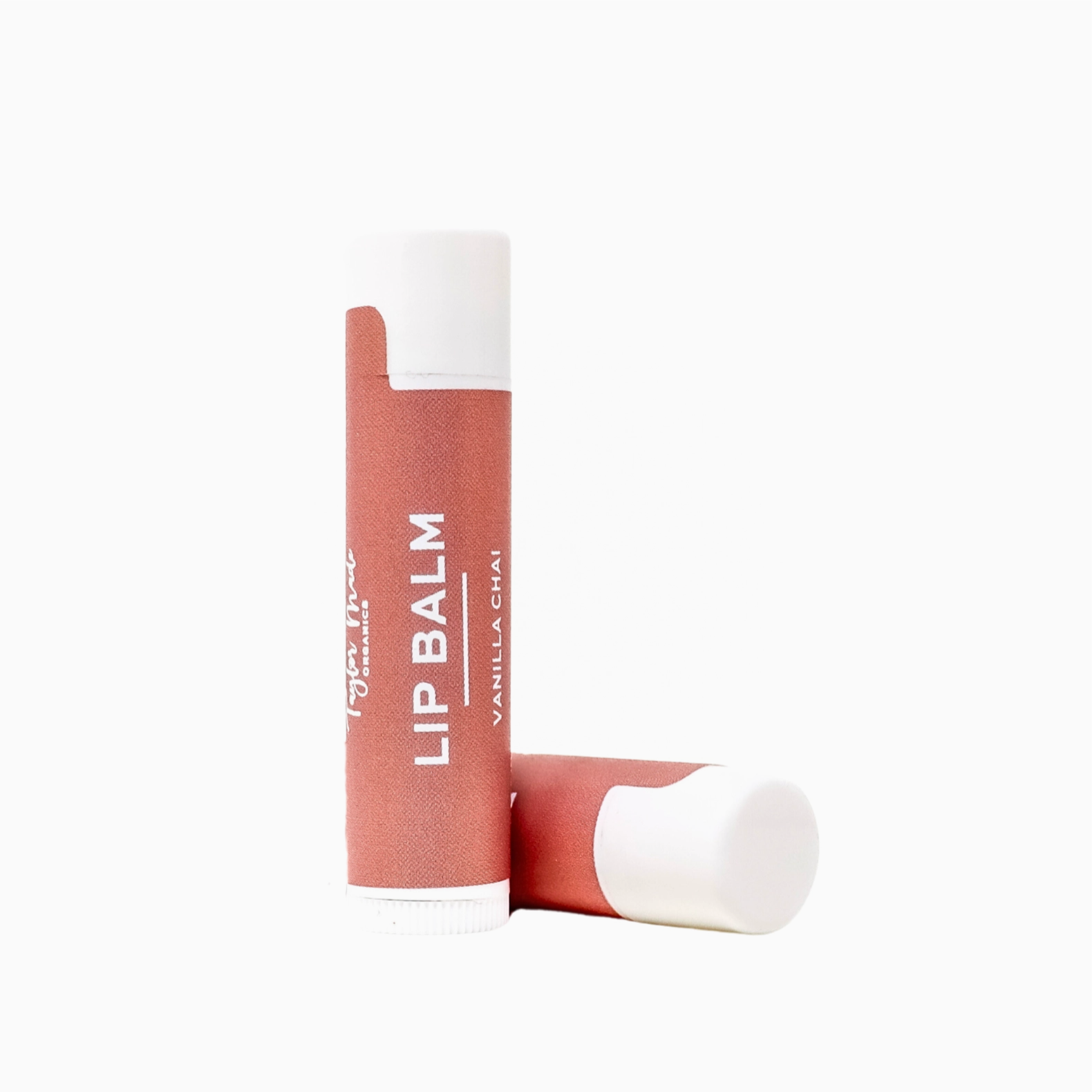 Lip balm with a white cap and reddish brown on a white background
