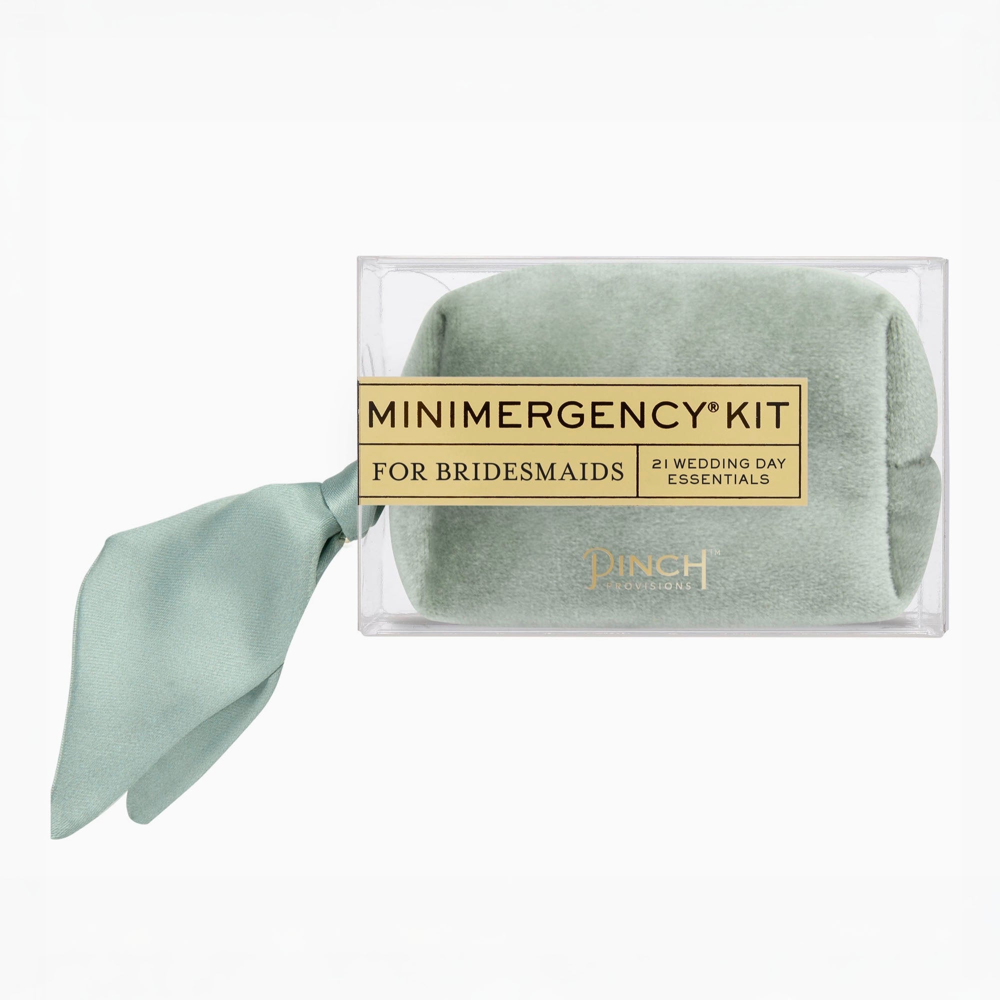 A packaged bridal emergency kit by Pinch Essentials, featuring a rolled sage green silk scarf inside a clear plastic box with a gold label that reads 'MINIMERGENCY KIT FOR BRIDESMAIDS' and a matching sage green ribbon tied to the side, on a white background.
