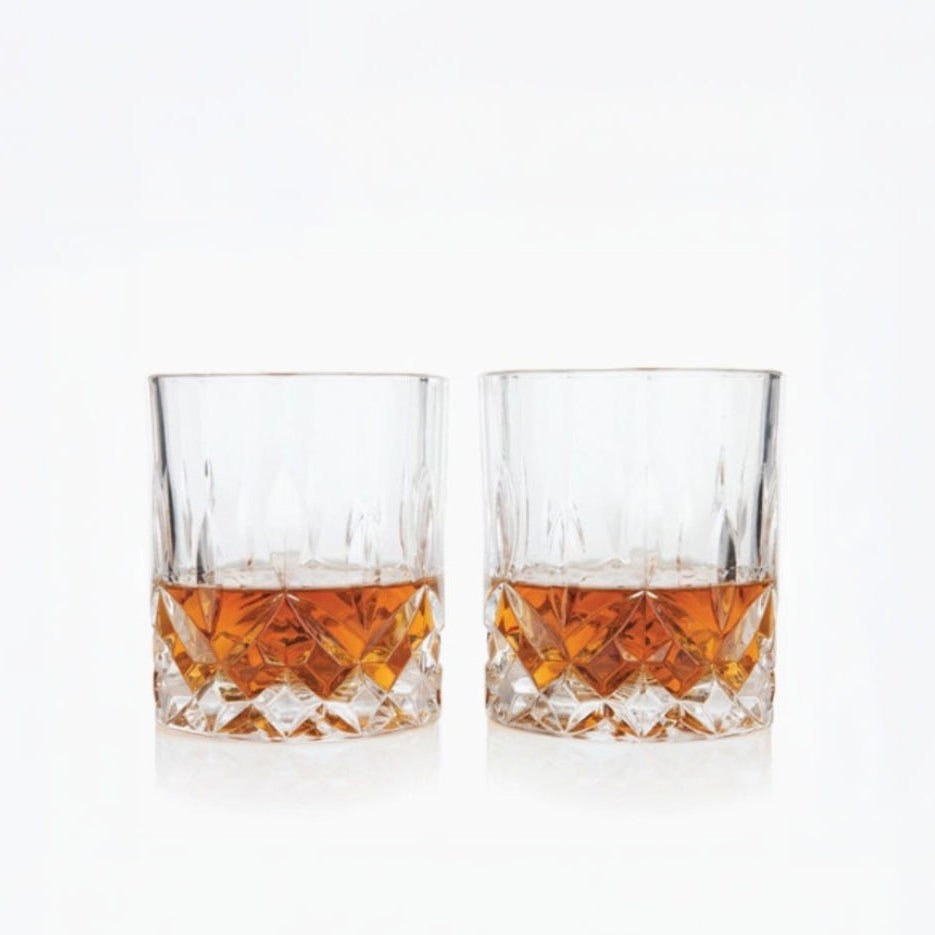 Two glasses of whiskey on a white background