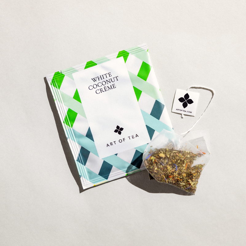 white tea sachet bag with blue and green geometrical lines with black letters. White coconut creme tea sachet from art of tea. 