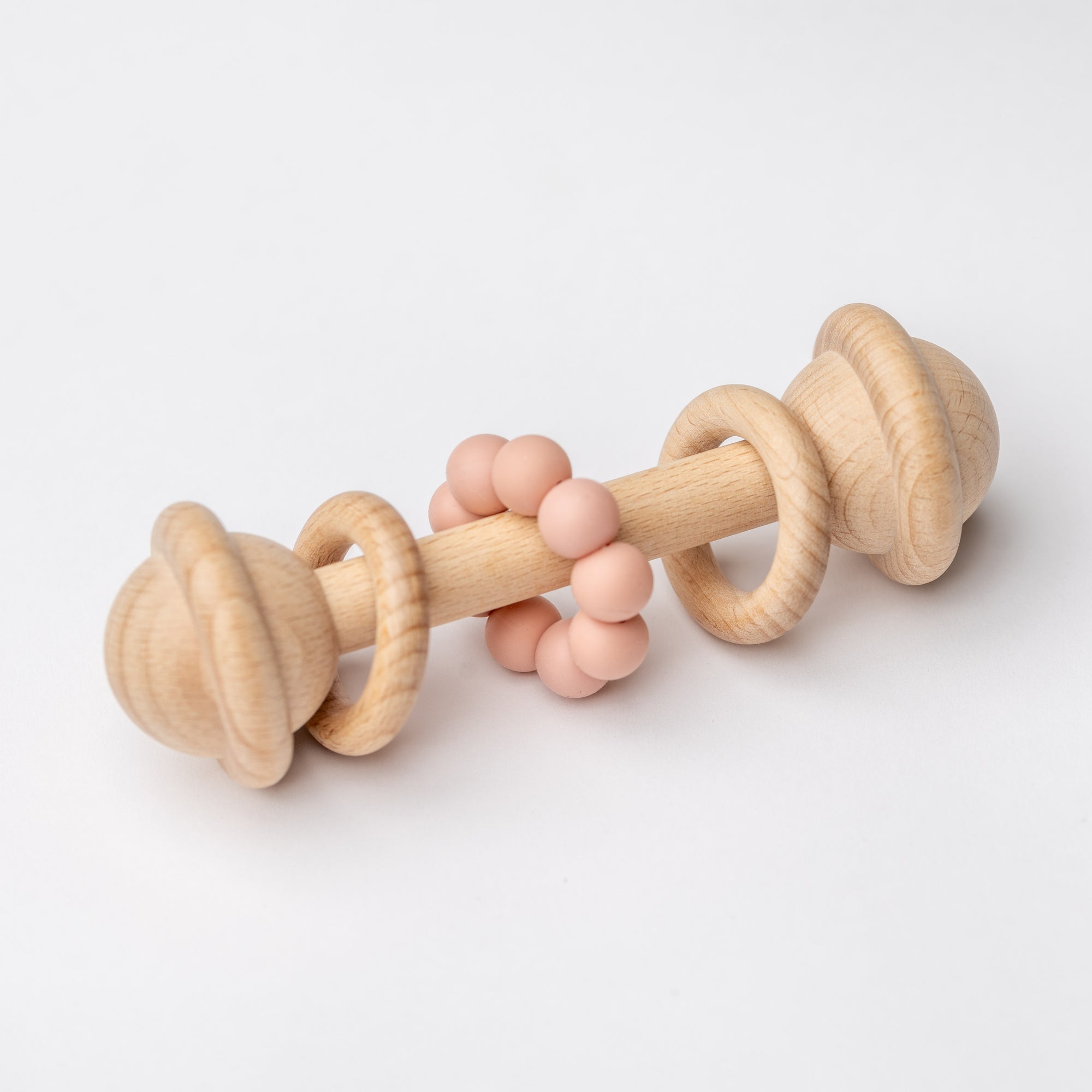 Natural wooden baby rattle with blush teething beads for infants.