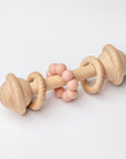 Natural wooden baby rattle with blush teething beads for infants.