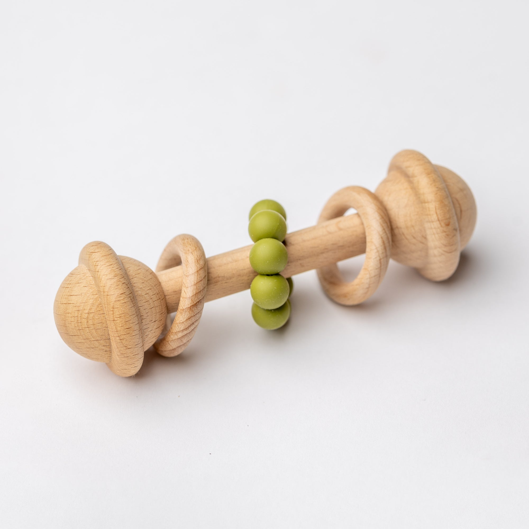 Natural wooden baby rattle with sage teething beads for infants.