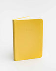 Yellow notebook with 'NOTES' embossed on the cover against a white background
