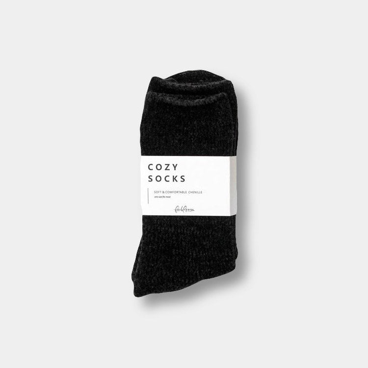Black pair of chenille socks. Has a white band around the center that reads "Cozy Socks"