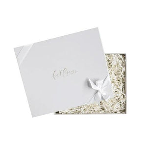 Light grey box embossed with foxblossom co. filled with white paper shred and tied with white ribbon.