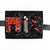 Black box with black paper shred containing a glass bottle of Truff hot sauce with black plastic faceted cap, clear plastic cube containing red hot cinnamon candies, a pair of black socks with red chili peppers design.