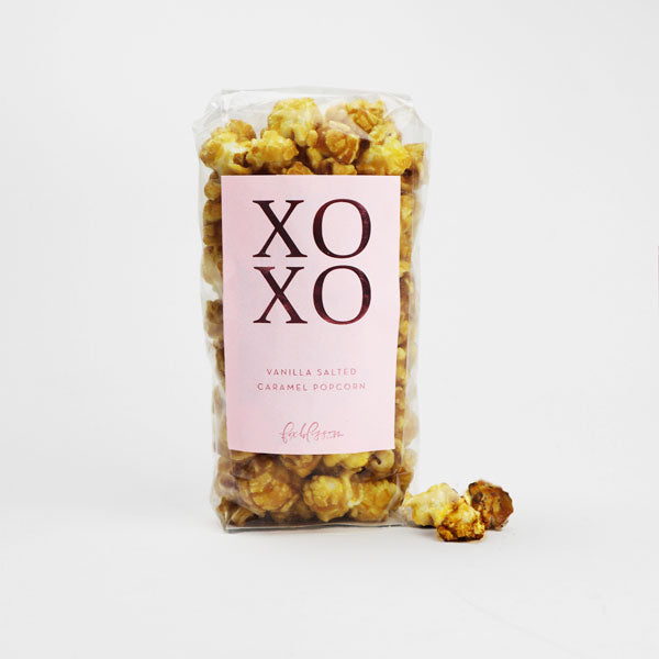 Vanilla salted caramel popcorn with a pink label that reads "XOXO" in dark pink foil.
