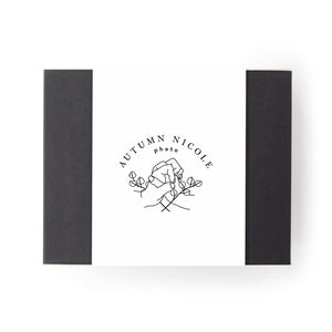 Black gifting box with white client logo band around center