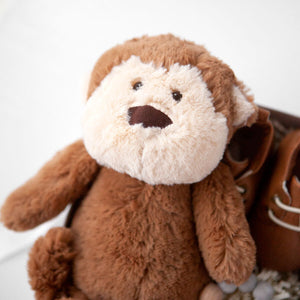 Close up image of Manhattan Toy Co Mocha Monkey plush. A brown monkey toy with a light cream face and brown body.