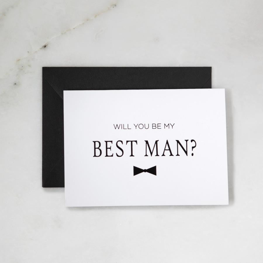 White envelope size card (approx. 3.5" x 5"), reads, "Will you be my best man?" in black text with a black bowtie graphic.