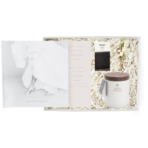 Elizabeth Laduca wedding book, mini Mast dark chocolate in white and brown package, dried floral bundle in neutral colors, Penrose Highgarden ceramic white candle with brown wooden lid. All in white cape cod gifting box with ivory paper shred